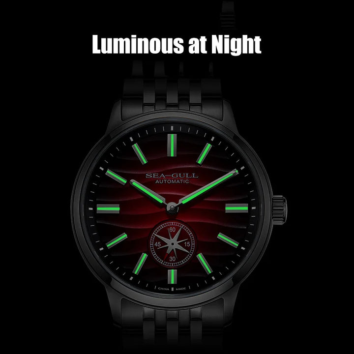 Black wristwatch with glowing green hands and red face on a black background, labeled 'Luminous at Night'.