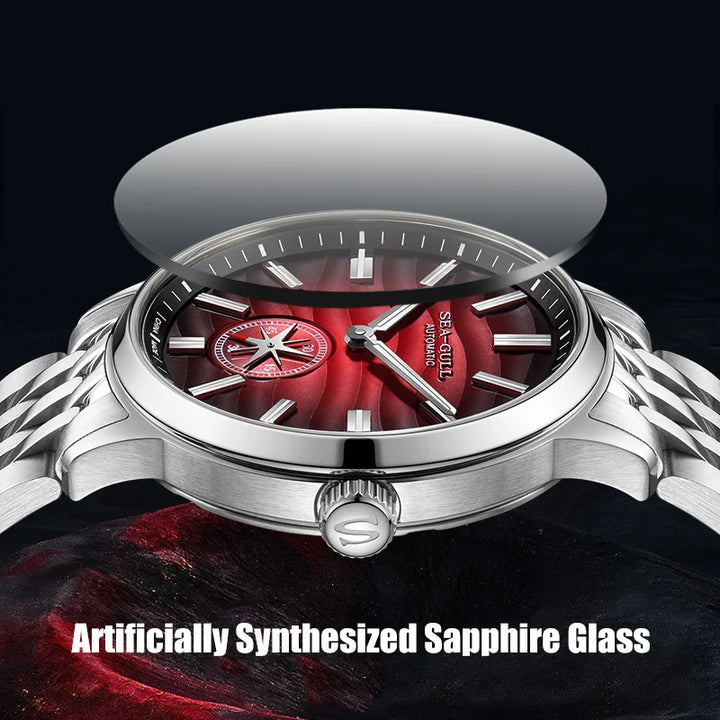 Watch with red face and silver case on a dark background, emphasizing artificial sapphire glass.