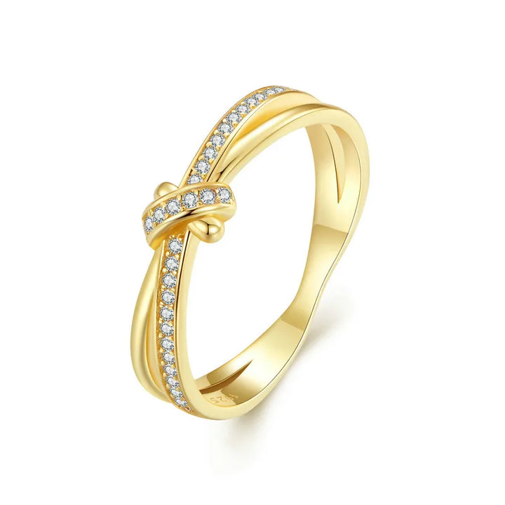 Gold ring with diamond accents on a white background