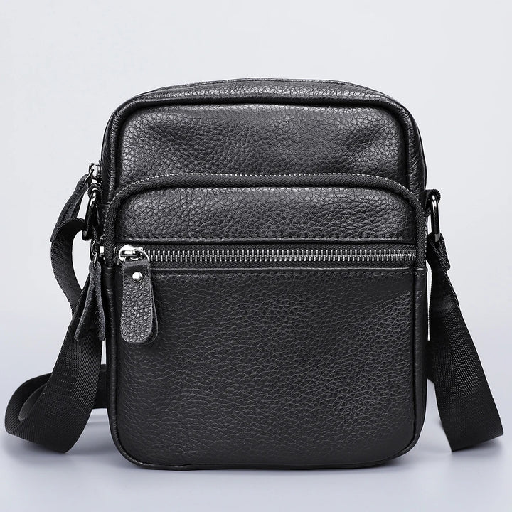 Black leather crossbody bag on a light gray background
