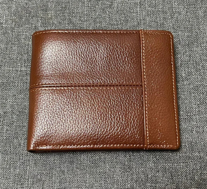 Brown leather wallet on a gray textured background