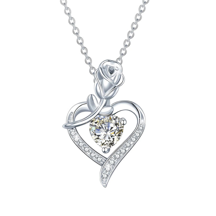Silver necklace with a heart-shaped pendant featuring a central gemstone on a white background