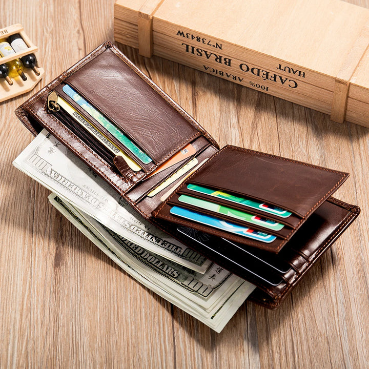 Brown leather wallet with cards and money on a wooden surface