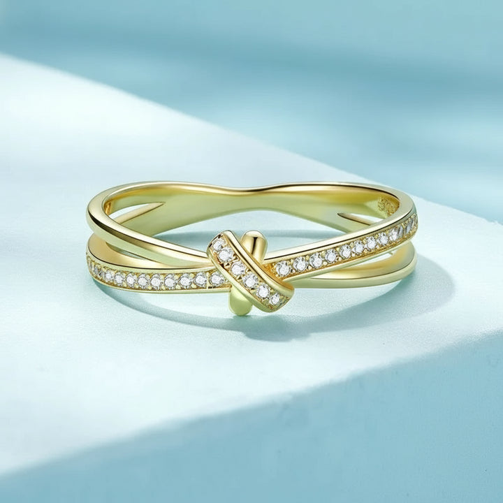 Gold ring with diamonds on a light blue background, featuring the Bamoer brand.