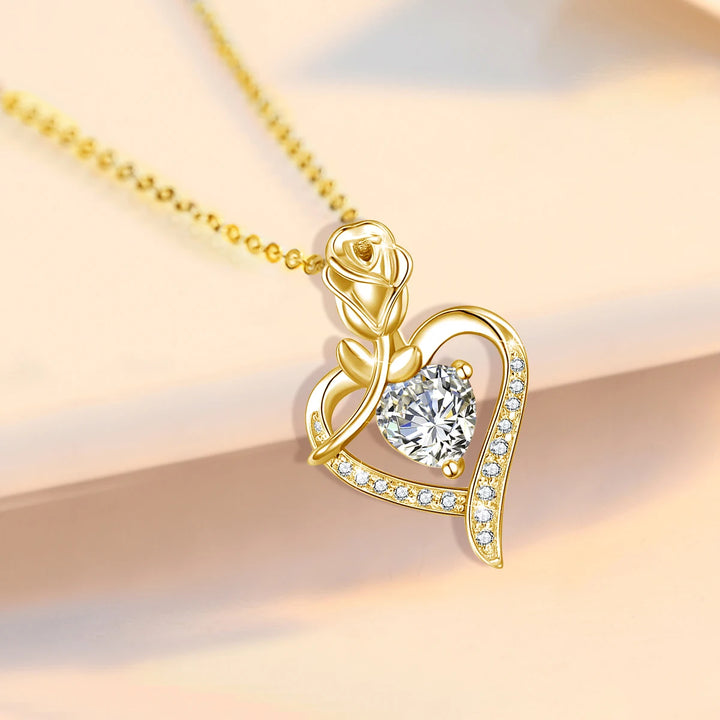 Gold necklace with a heart-shaped pendant featuring a diamond on a soft background